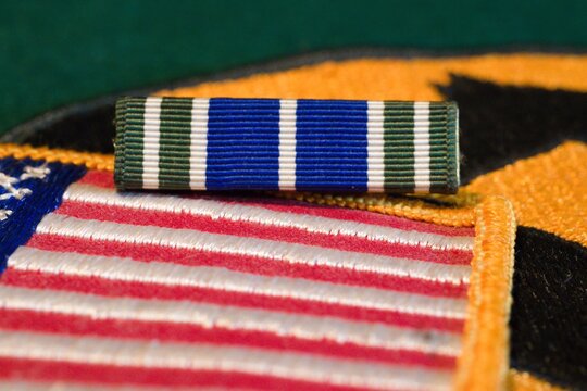 Close-up of USA Flag, Army medal, and patch