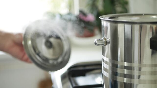 Shooting with a Pot in the Kitchen Making Steam and Boiling Some Food, Preparing the Meal. 