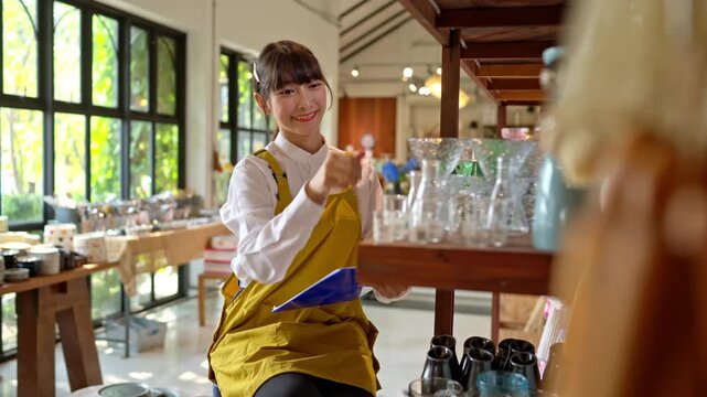 Shop staff organizing products and checking inventory on shelves in a handmade ceramic and home decor store