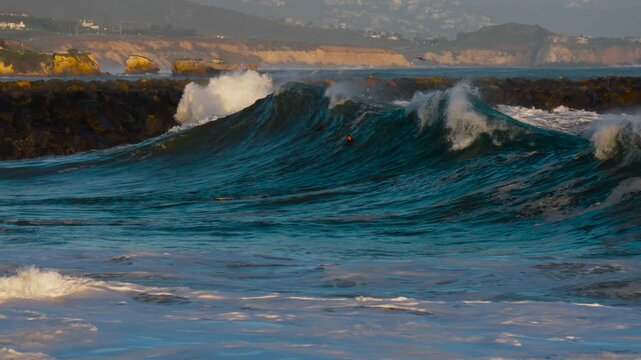 Giant shorebreak crashing on the sand at the wedge