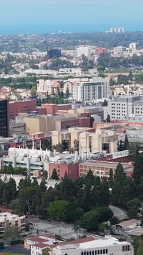 High altitude flight over UCLA Health Campus, with Westwood, Century City and Pacific Ocean visible in far background of the cityscape