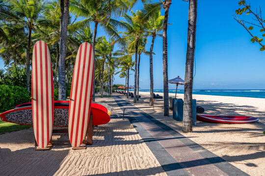 Luxury Tropical Beach with Surfboards and Palm Trees in Nusa Dua, Bali, Indonesia
