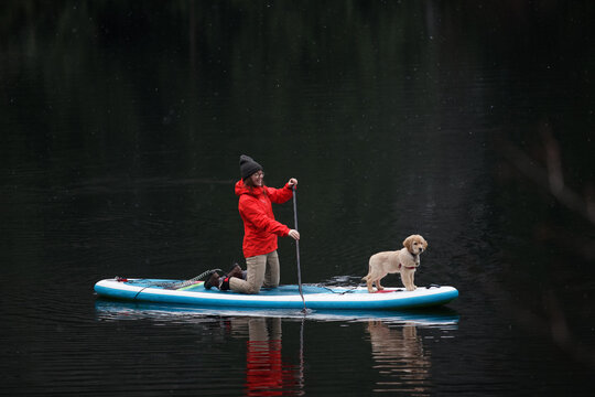 Paddleboarding with a puppy on a snowy winter morning