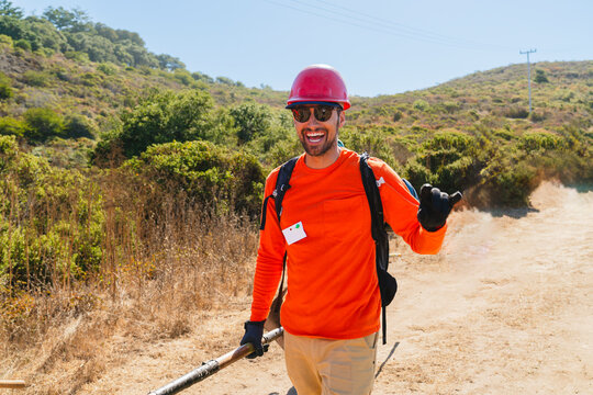 happy construction worker outside Volunteering trail building 