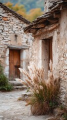 Fototapeta premium Pampas grass adorns a rustic stone home in a serene countryside setting.