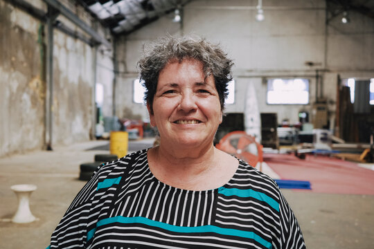 Woman Smiles in a Spacious loft Workshop 
