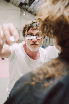 Creative hairdresser Director Interacts With Model 
