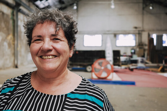 Portrait of a smiling woman in an Industrial Space