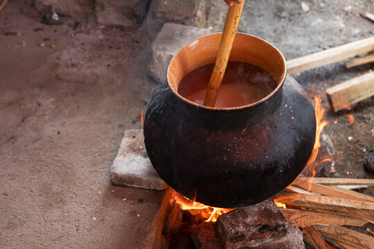 Traditional cooking in a clay pot over fire