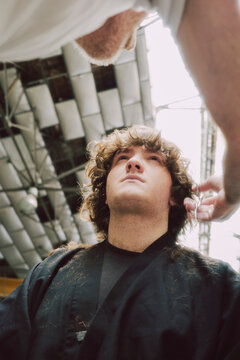 Barber Giving Haircut to teen z generation