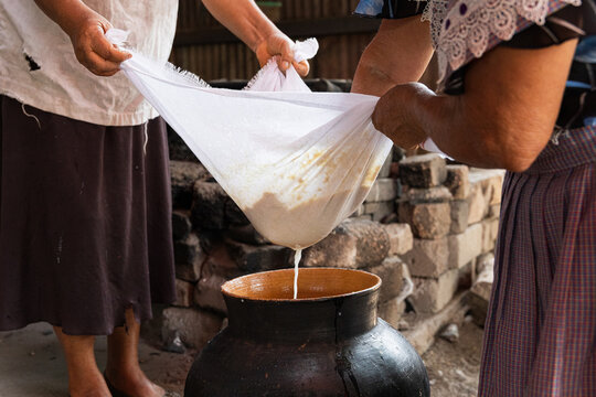 Traditional method of straining corn atole