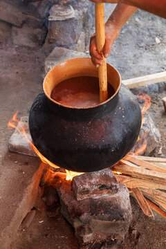 Stirring Ingredients in Traditional Clay Pot