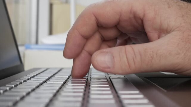 Hand Typing on Laptop Keyboard Closeup Detail