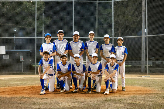 Baseball Team Poses on Field at Night