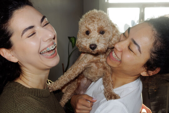 portrait of two young women with a dog
