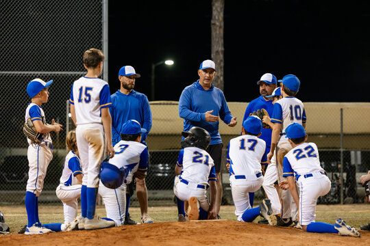 Coaches Give Team Talk During Baseball Game