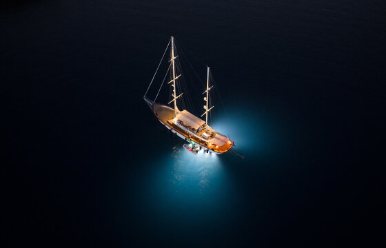 Sailing Yacht with backlight under water, drone shot