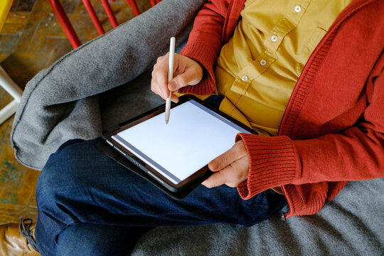 Close-up of designer hands drawing on graphic tablet