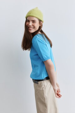 Portrait happy woman in bright hat white background