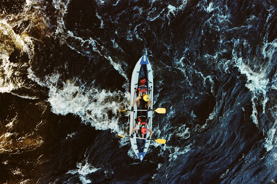 Kayakers navigate the river in bright sunlight