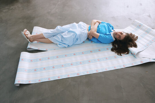 Portrait woman lying on pastel color backdrop