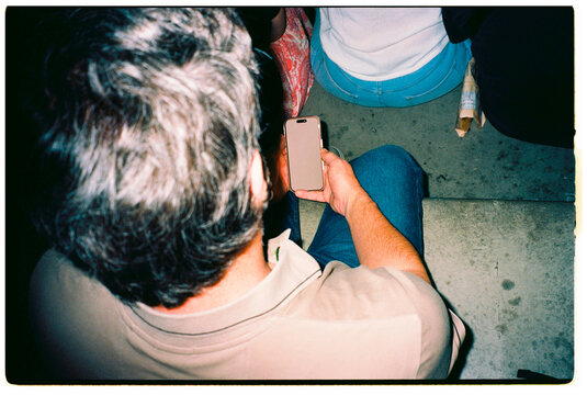 Man Using Smartphone in Stadium Stands