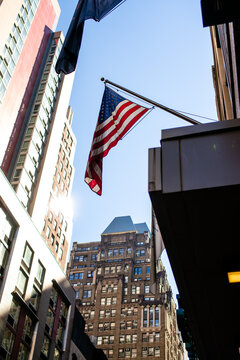 Flag of the United States against New York urban architecture