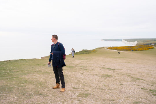 Traveler exploring Seven Sisters Cliffs coastline in the UK