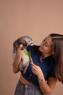 Woman Playing With Pet Ferret