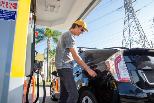 Man Filling Sedan with Gas