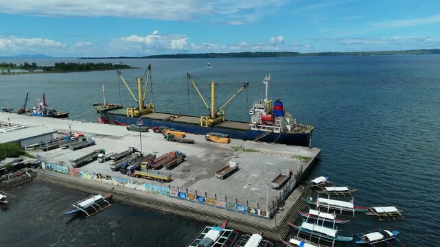 Aerial view reveals a bustling port setting in Tabaco City, Philippines. Ideal for business and transportation concepts.