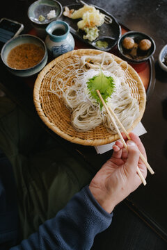 Man eating cold soba for breakfast