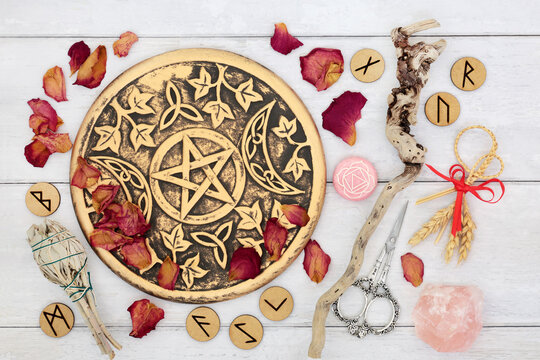 Witchcraft magical occult equipment and ingredients for lovers with ritual objects, rose quartz, sage smudge stick, runes, rose petals, wand, white magic symbols.