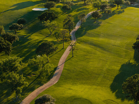 Aerial view of golf course fairway with winding cart path