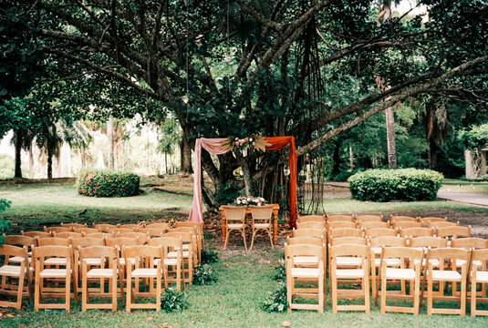 Outdoor wedding ceremony setup in tropical garden
