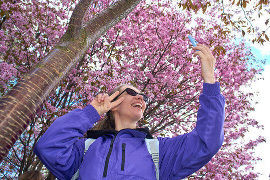 Low angle shot of woman taking selfie 