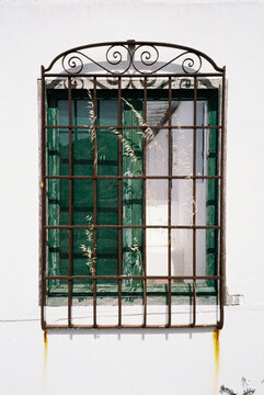 Rustic window with green shutters 