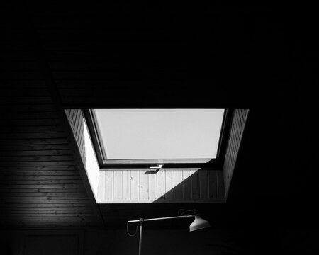 Black and White Skylight in Dark Attic Interior
