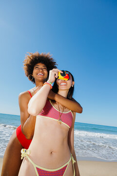 Friends enjoying beach vacation taking travel memory