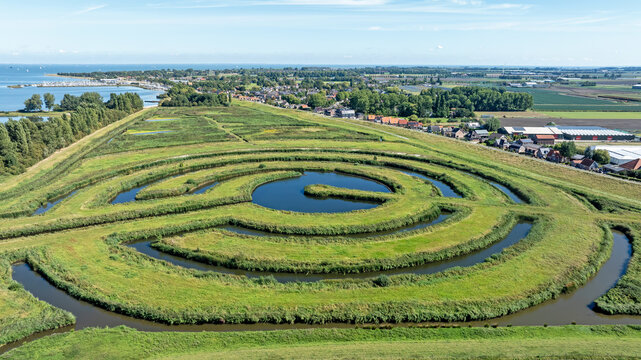 Experimental water landscape with spiral pattern in a Dutch polder in Europe