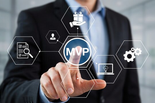 Businessman touching a virtual interface with an mvp minimum viable product icon in a business concept