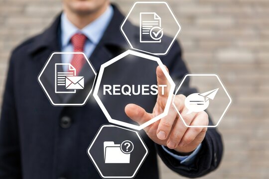 Businessman pressing a virtual button with the word request on a digital interface screen