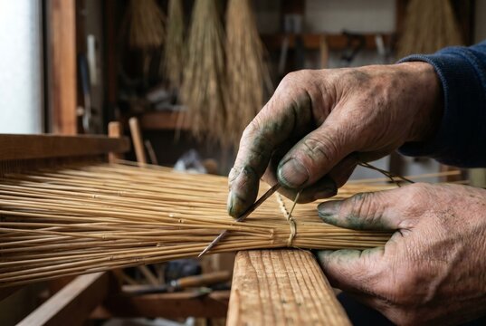 Master Tatami Maker Hands Threading Rice Straw with Needle in Traditional Japanese Workshop Craftsmanship Concept
