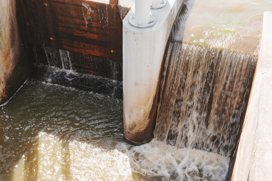 White Water Cascades Over Concrete Dam Spillway with Wooden Beams Industrial Engineering Flow for Power Generation and Water Management