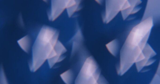 Defocused color glow. Flicker light. Blue white flare radiant art glare illuminated flash on abstract optical luminous background.