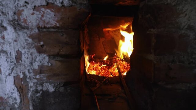 Fire Burning Inside a Rustic Brick Oven