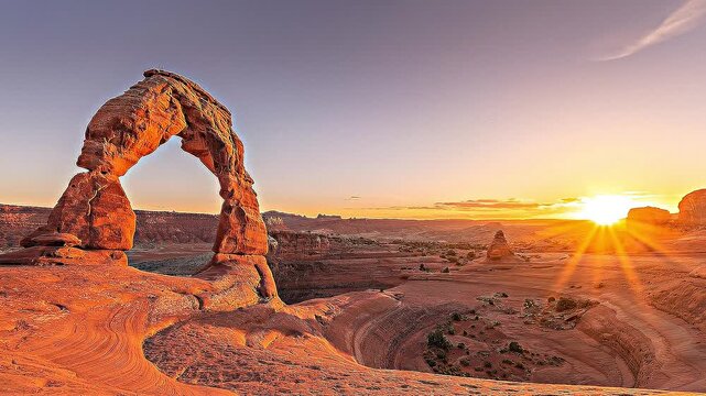 Delicate arch sunset time lapse over sandstone desert landscape in arches national park utah.