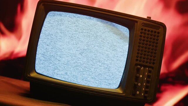 Retro TV, vintage television In a nostalgic setup, a retro TV displays grain on screen, scary halloween night device good for chroma key and green screen.