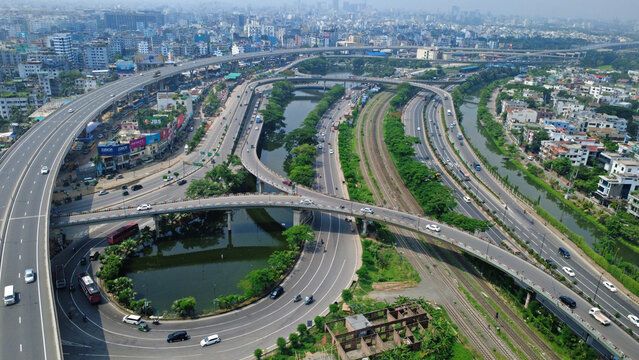 This impressive aerial view of Dhaka highlights the modern infrastructure and dynamic urban landscape of Bangladesh&rsquo;s capital. The image showcases a network of elevated flyovers, highways, rail lines.