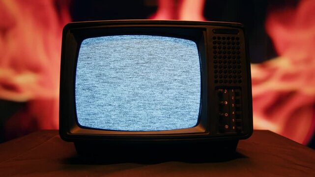 Retro TV, vintage television In a nostalgic setup, a retro TV displays grain on screen, scary halloween night device good for chroma key and green screen.